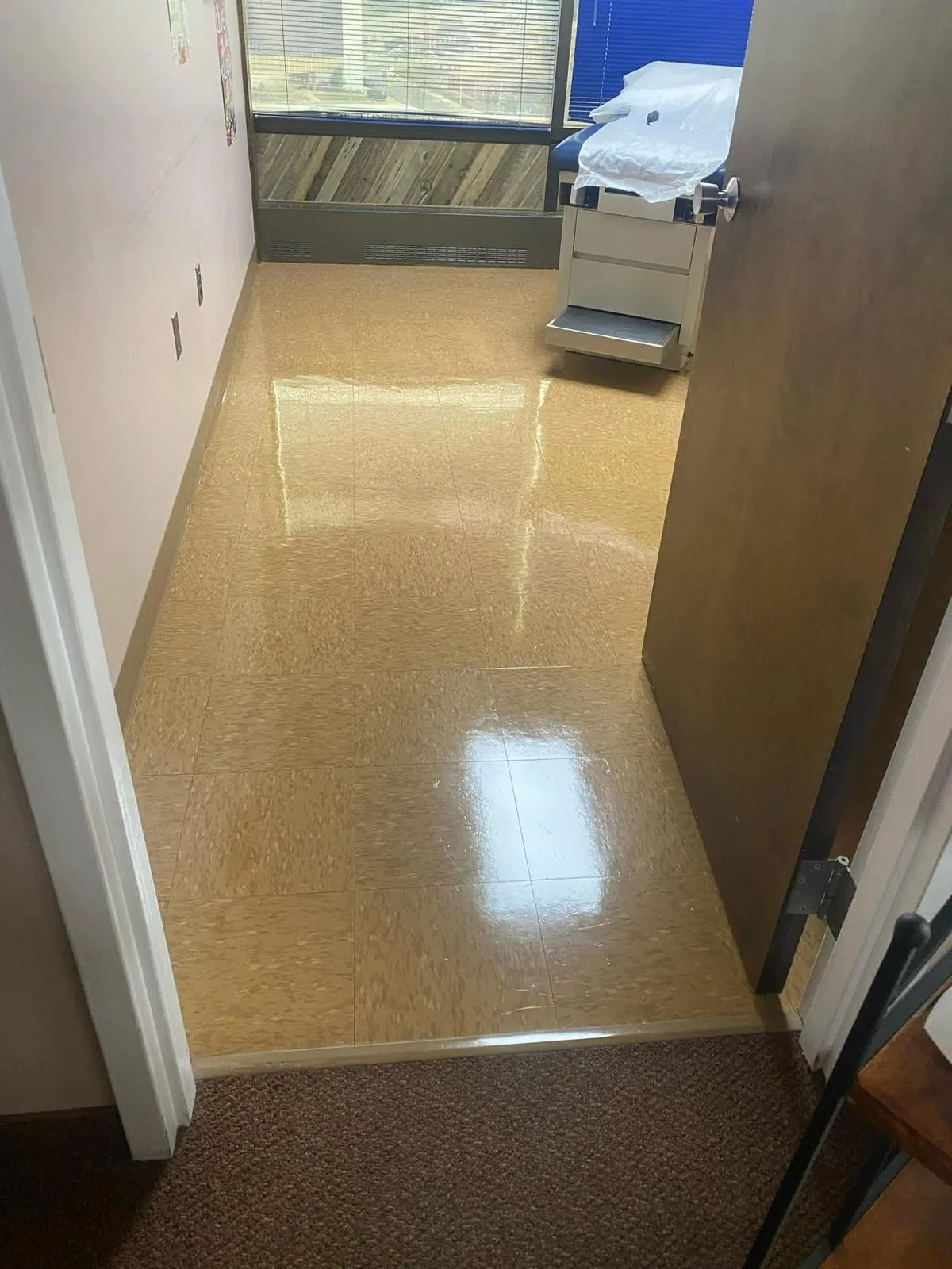 Glossy waxed floor in a clinic exam room