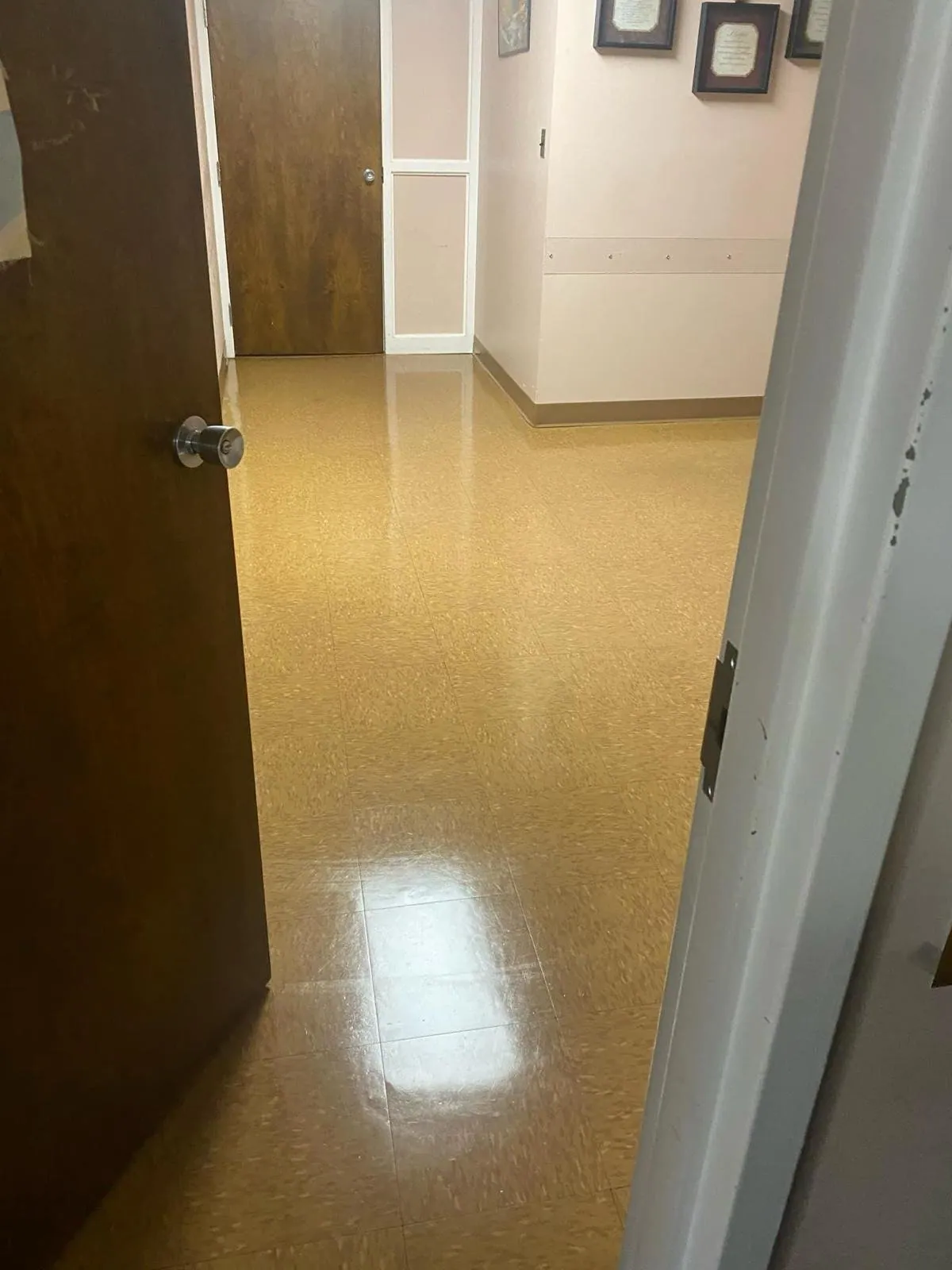 Shiny waxed floor seen through a doorway in a medical office